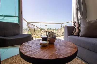 a wooden coffee table in a living room with a view at Seafront Stylish Apt, Protaras in Protaras