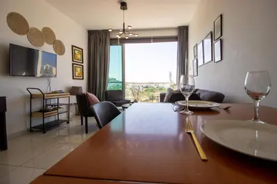 a living room with a table with wine glasses on it at Seafront Stylish Apt, Protaras in Protaras