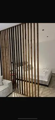 a bed with a wooden fence in a room at Calavato Cottage in Kalavasos