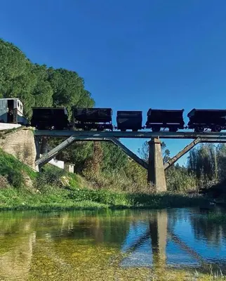 a train on a bridge over a body of water at Calavato Cottage in Kalavasos
