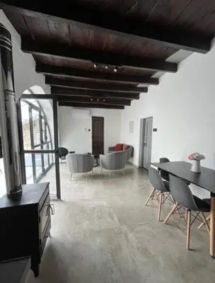 a living room with a table and chairs at Calavato Cottage in Kalavasos