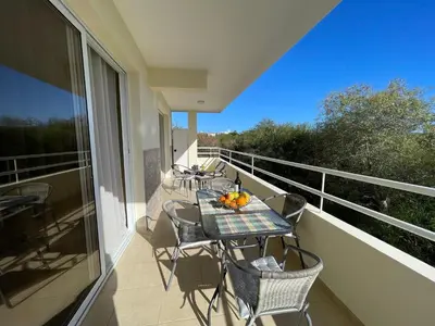 a balcony with a table and chairs on a balcony at Nissi Beach beautiful apartment in Ayia Napa
