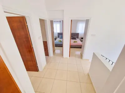 a hallway with a room with a bed and a staircase at Villa Malama in Paralimni