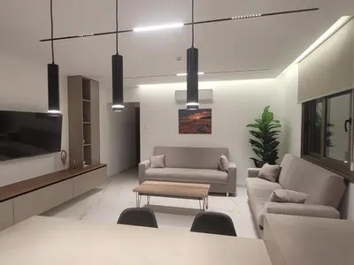 a living room with two couches and a coffee table at IOLENA Seaview Apartment in Pyla