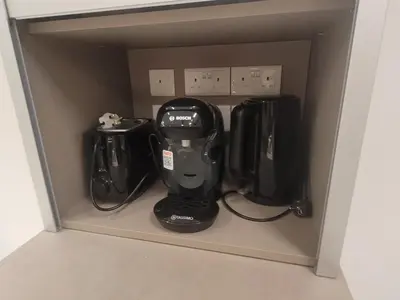 a cupboard with a coffee maker and other appliances at IOLENA Seaview Apartment in Pyla