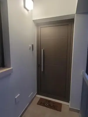 a door in a room with a sign that says home at IOLENA Seaview Apartment in Pyla