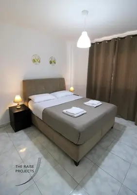 a bedroom with a bed with two towels on it at Raise Limassol Coastal City Break in Limassol