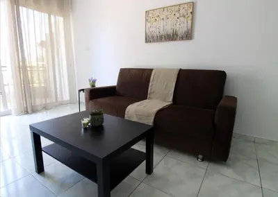 a living room with a couch and a coffee table at Raise Limassol Coastal City Break in Limassol