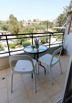 a table and two chairs on a balcony at Raise Limassol Coastal City Break in Limassol