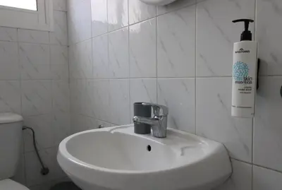 a white bathroom with a sink and a toilet at Raise Limassol Coastal City Break in Limassol