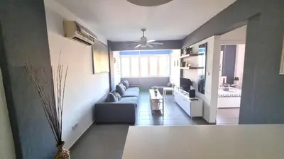 a living room with a couch and a tv at Beachside Comfort - 2Br Apt,5 Min to the Beach in Larnaka