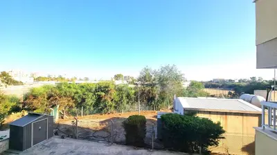 a view of a yard from a building at Beachside Comfort - 2Br Apt,5 Min to the Beach in Larnaka