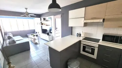a kitchen with a white counter top in a room at Beachside Comfort - 2Br Apt,5 Min to the Beach in Larnaka