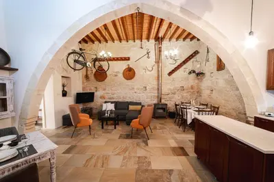 a dining room with an archway and a table and chairs at Villa To Palati with Private Pool Anogyra in Anoyira