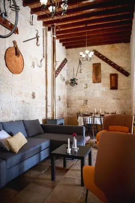 a living room with a couch and a table at Villa To Palati with Private Pool Anogyra in Anoyira