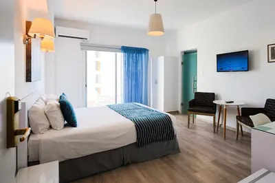 a hotel room with a bed and a window at Mikes Kanarium City Hotel in Larnaka