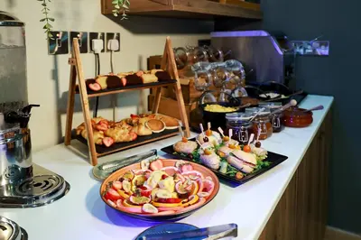 a buffet of food on a counter in a kitchen at Mikes Kanarium City Hotel in Larnaka