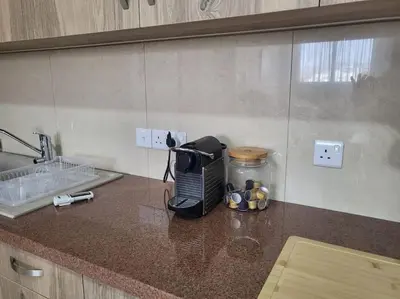 a kitchen counter with a coffee maker on a counter top at Limassol mountain and sea views in Limassol