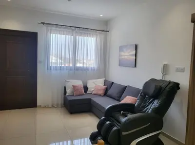 a living room with a couch and a chair at Limassol mountain and sea views in Limassol