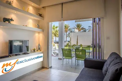 a living room with a couch and a dining room at Villa Nora in Protaras