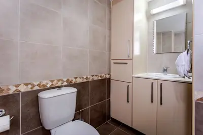 a bathroom with a toilet and a sink at Villa Nora in Protaras