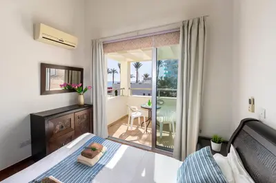 a bedroom with a bed and a balcony at Villa Nora in Protaras
