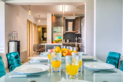 a dining room table with glasses of orange juice at Beachfront Trident in Protaras