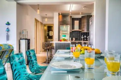 a dining room with a table with glasses of orange juice at Beachfront Trident in Protaras