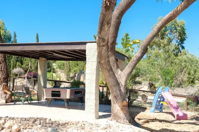 a picnic shelter with a tree and a slide at Villa Heaven in Protaras