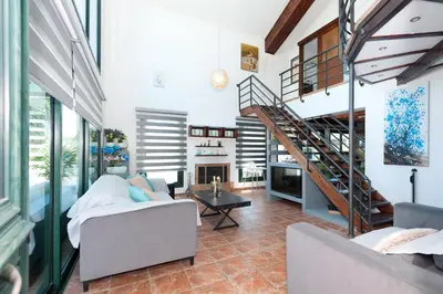 a living room with a staircase and a couch at Villa Heaven in Protaras