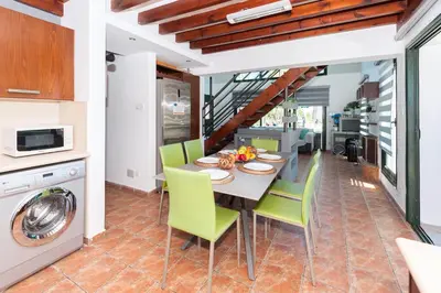 a kitchen and dining room with a table and chairs at Villa Heaven in Protaras