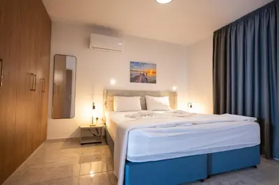 a bedroom with a large white bed in a room at Luca Apts Napa in Ayia Napa