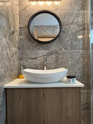 a bathroom with a sink and a mirror at Luca Apts Napa in Ayia Napa