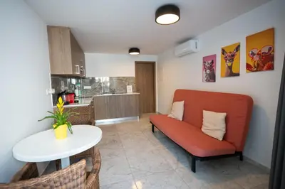 a living room with a couch and a table at Luca Apts Napa in Ayia Napa
