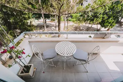 a patio with a table and chairs on a balcony at Neapolis Residence Spacious Quiet Near beach in Limassol
