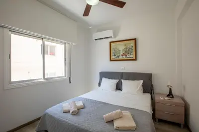 a bedroom with a bed with two towels on it at Neapolis Residence Spacious Quiet Near beach in Limassol