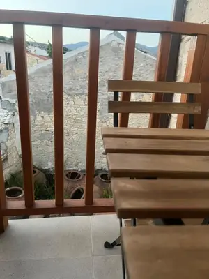 a balcony with a bench and a view of the beach at Stin Avli tou Pavlou Guest House in Omodos