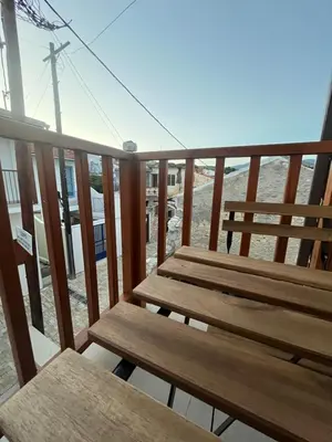 a pair of wooden benches sitting on a balcony at Stin Avli tou Pavlou Guest House in Omodos