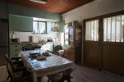 a kitchen with a table and a kitchen with a stove at Omodos Serenity House in Omodos