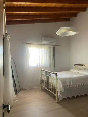 a bedroom with a bed and a window at Omodos Serenity House in Omodos
