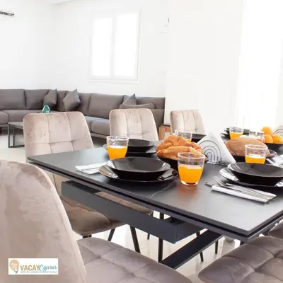 a dining room table with food and orange juice on it at Villa Orash in Larnaka