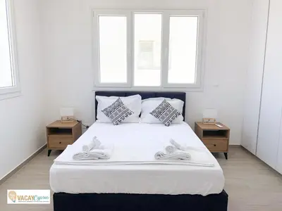 a bedroom with a large bed with two night stands at Villa Orash in Larnaka