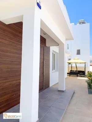 a porch of a house with a wooden door at Villa Orash in Larnaka