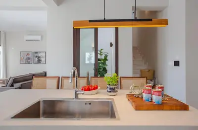 a kitchen with a sink and a counter top with a sink at LIV & CO Suites & Villas in Voroklini