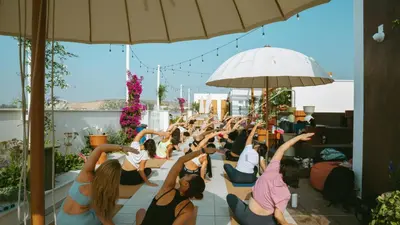 a group of people doing yoga on a roof at LIV & CO Suites & Villas in Voroklini