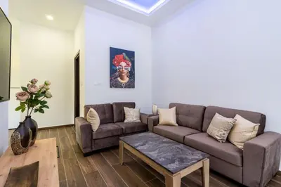 a living room with a couch and a table at Aura 2-Bedroom Apartment in Larnaca in Larnaka