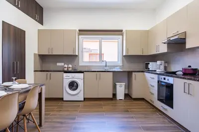 a kitchen with a sink and a washing machine at Aura 2-Bedroom Apartment in Larnaca in Larnaka