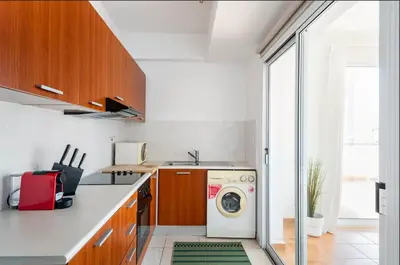 a kitchen with a washer and dryer in it at Top Floor Apartment City Center in Larnaka