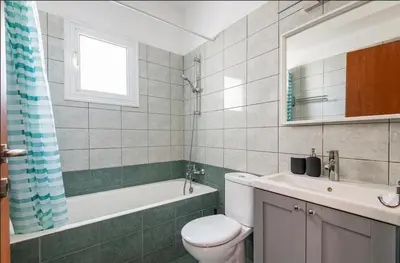 a bathroom with a toilet and a sink and a tub at Top Floor Apartment City Center in Larnaka