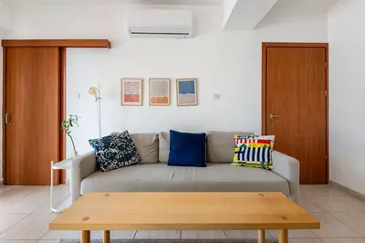 a living room with a couch and a coffee table at Top Floor Apartment City Center in Larnaka